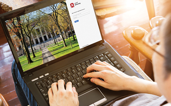 Student looking at laptop screen of the their schools sign in page to access OnTheHub