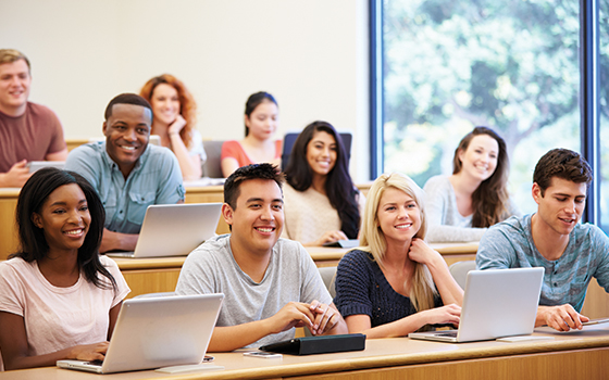 Image of students with laptops in a lecture classroom