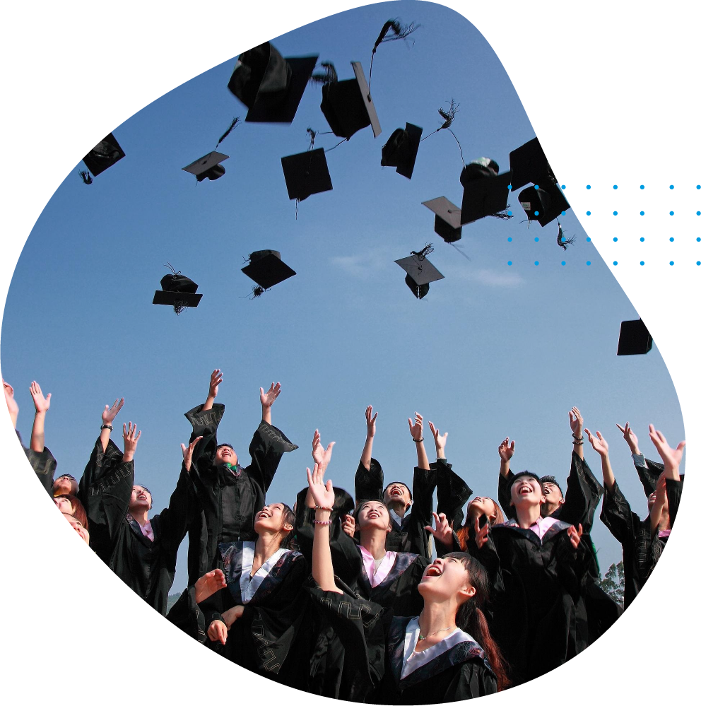 Graduating students throwing their caps in the air